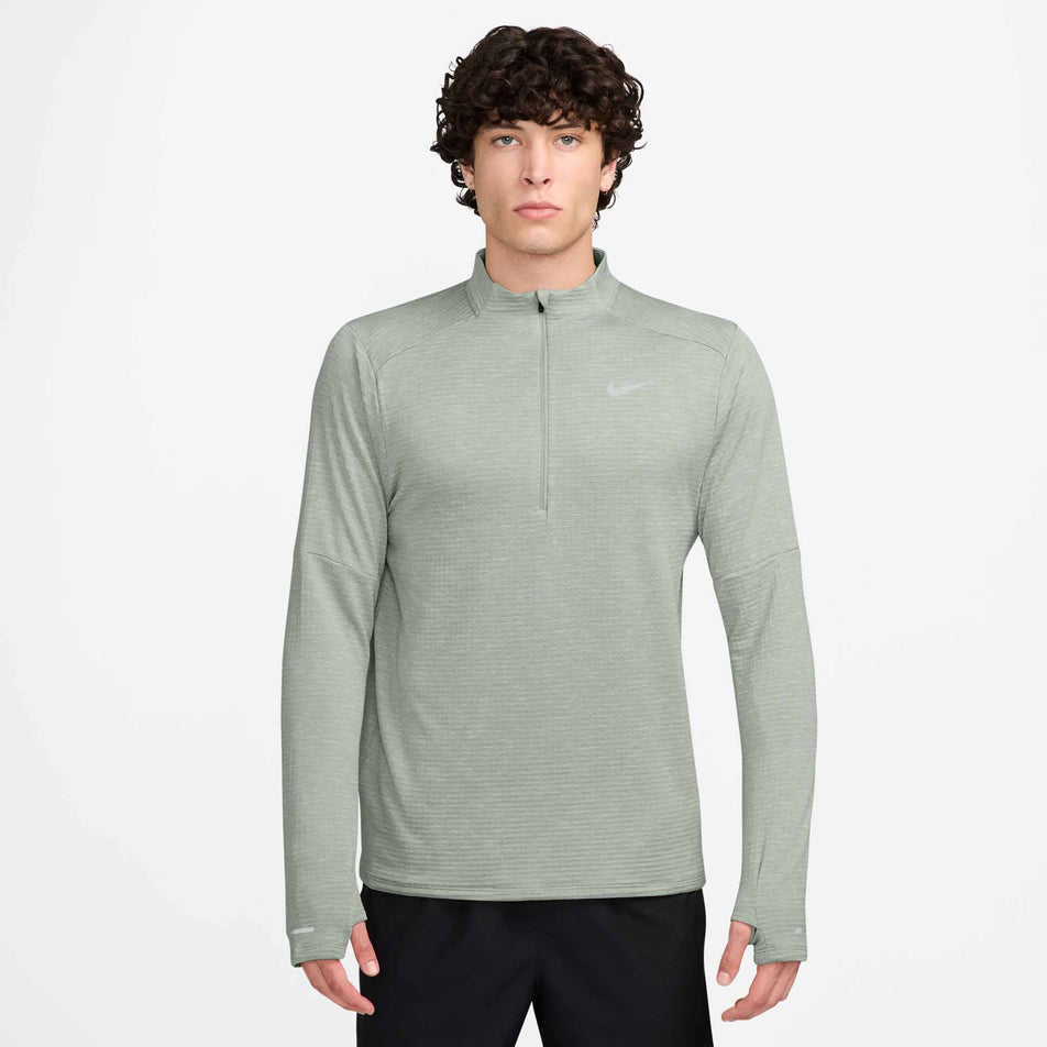 The front view of a model wearing a Nike Men's Therma-FIT Water-Repellent Element 1/2-Zip Running Top in the Jade Horizon/Reflective Silv colourway. Model is also wearing Nike shorts. (8497732518050)