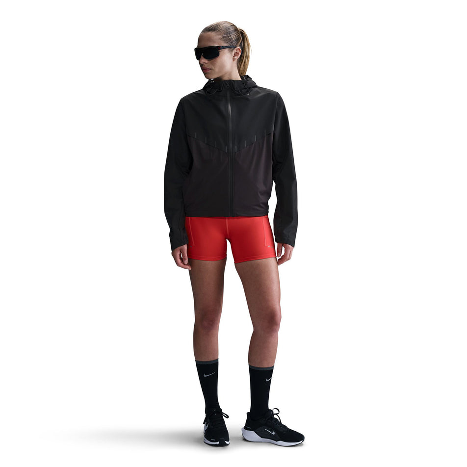 Front view of a model wearing the Nike Women's AeroSwift Aerogami Storm-FIT Running Jacket in the Black/Black colourway.