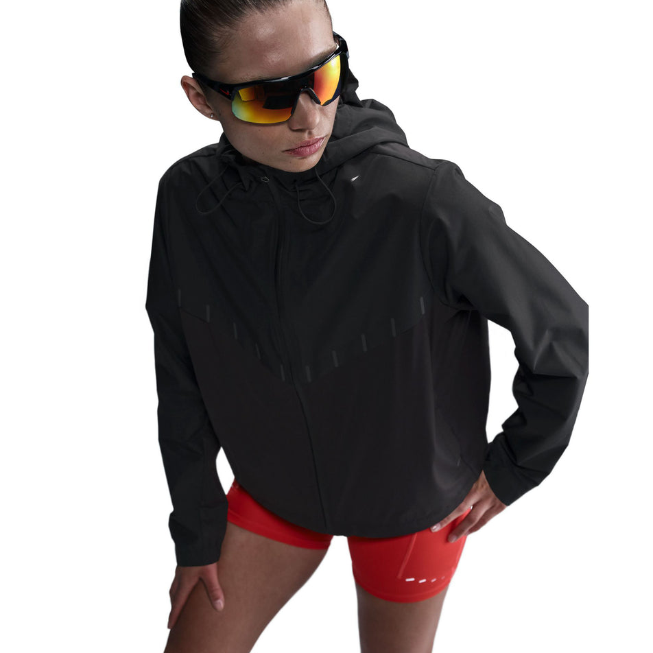 Front view of a model wearing the Nike Women's AeroSwift Aerogami Storm-FIT Running Jacket in the Black/Black colourway.