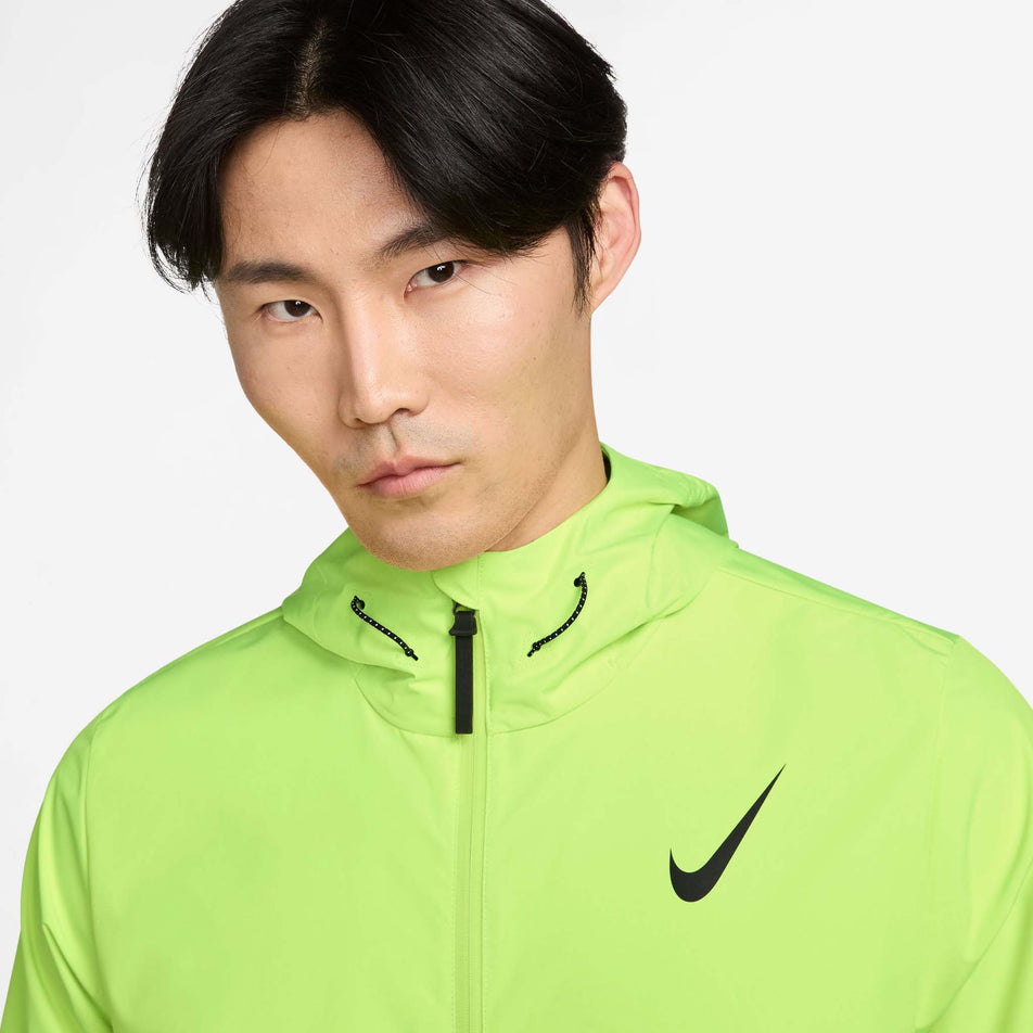 Front view of a model wearing the Nike Men's AeroSwift Storm-FIT Aerogami Running Jacket in the Volt/Black colourway. (8778192093346)