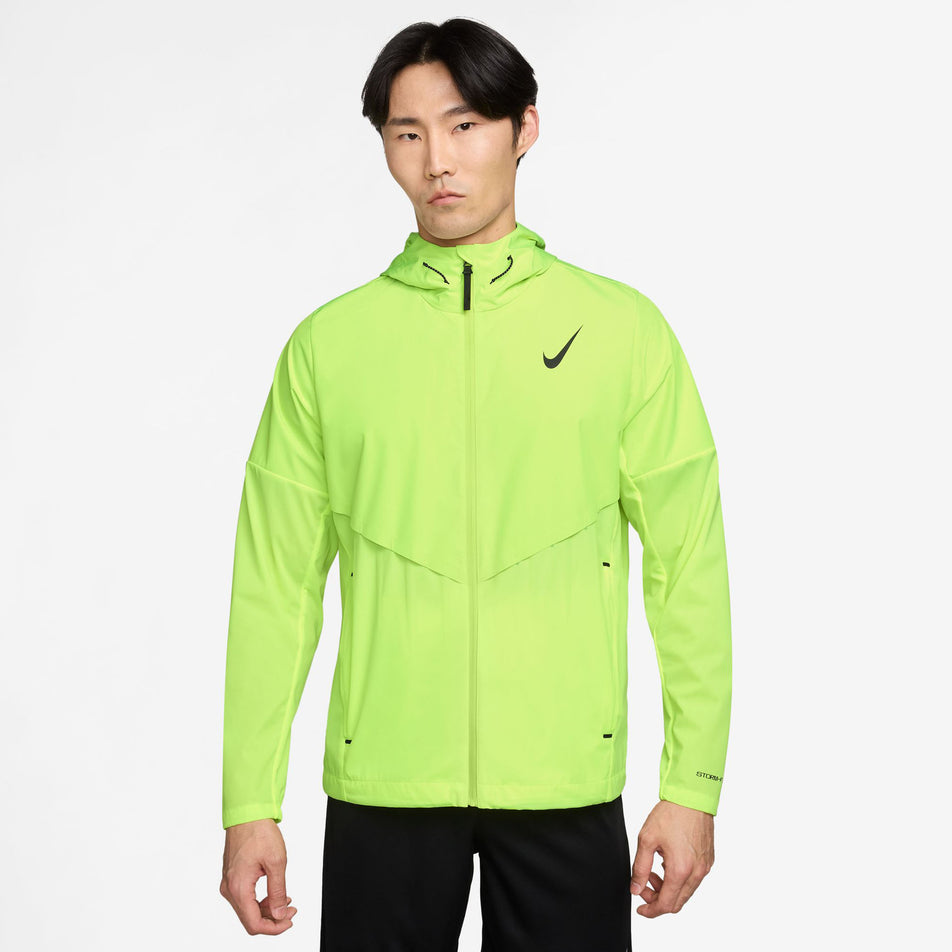Front view of a model wearing the Nike Men's AeroSwift Storm-FIT Aerogami Running Jacket in the Volt/Black colourway.(8778192093346)