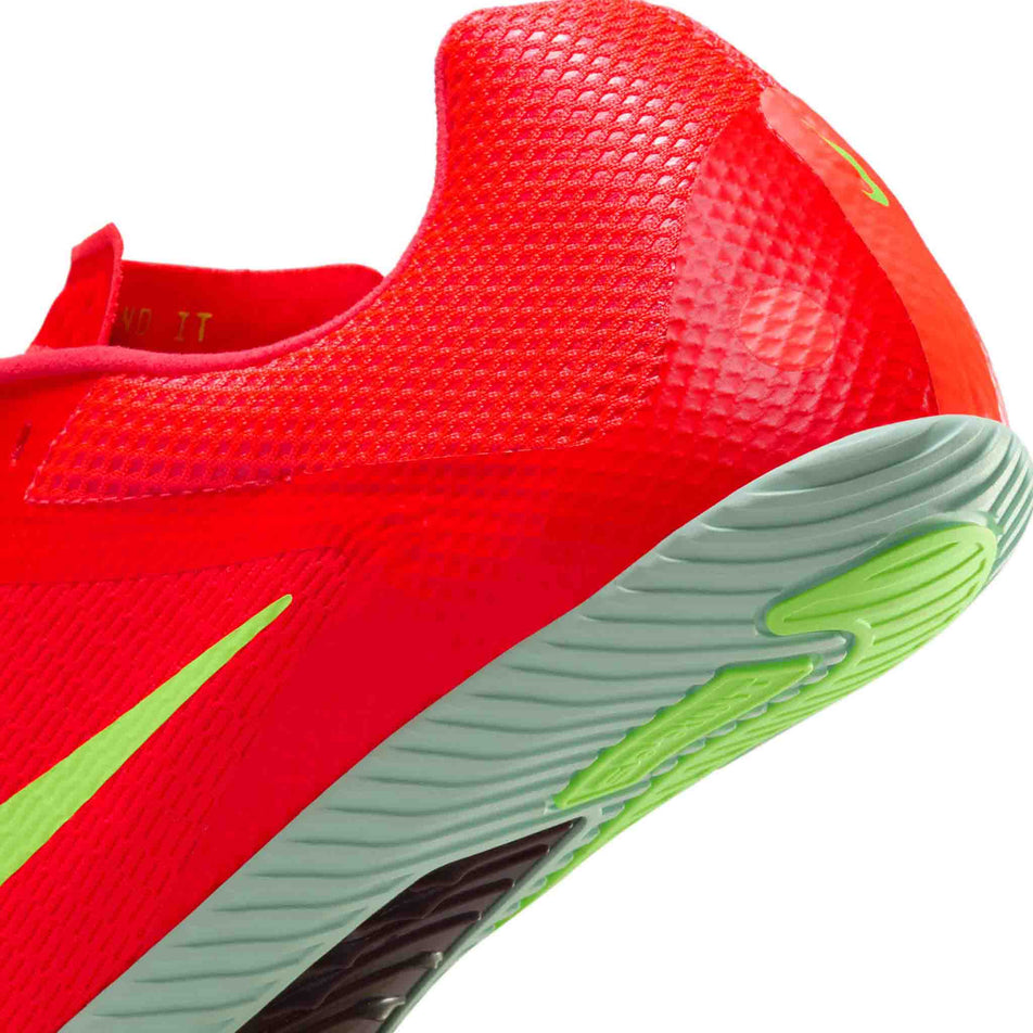 Close up of the heel area of the left shoe from a pair of Nike Unisex Zoom Rival Sprint Track & Field Sprinting Spikes in the Bright Crimson/Washed Coral-Hyper Orange colourway. (8654086111394)
