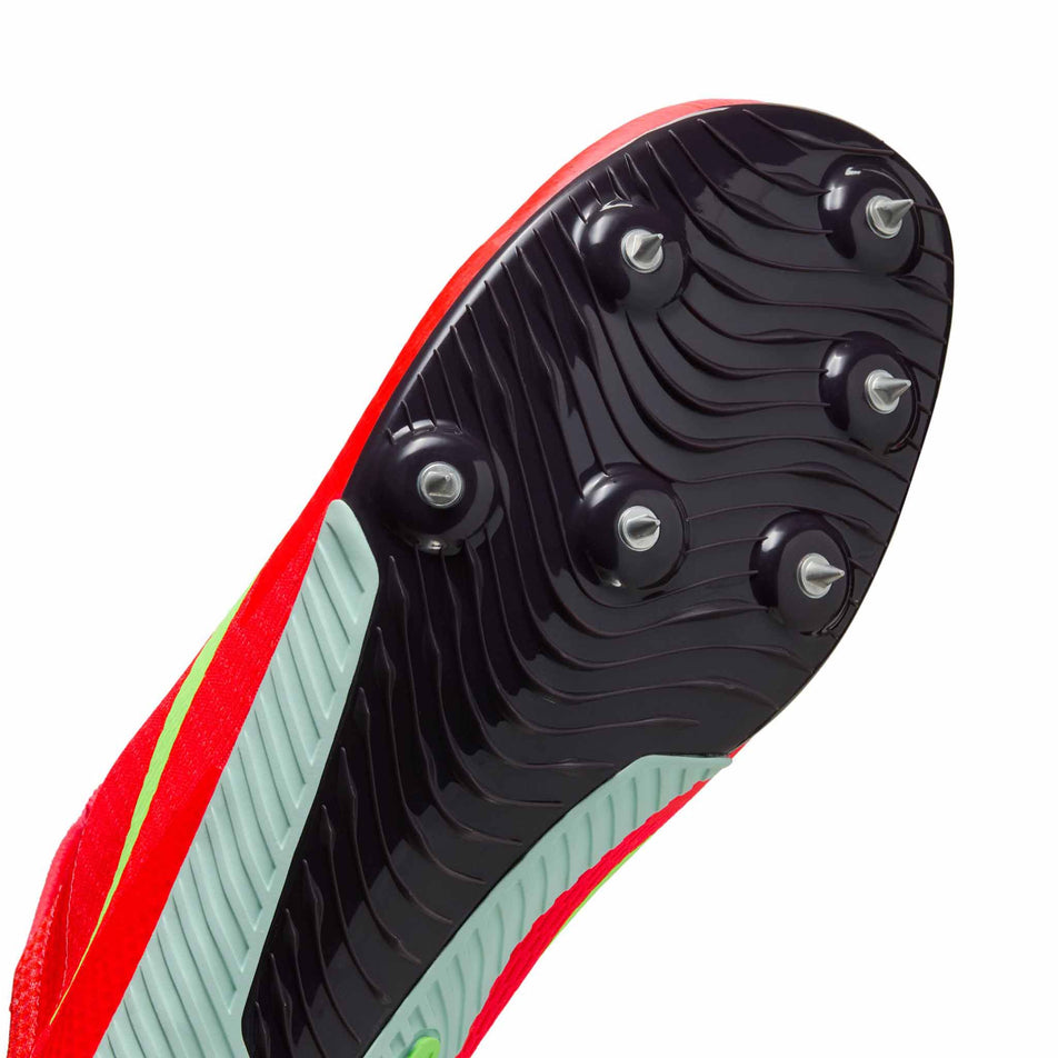 Close up of the spike plate of the right shoe from a pair of Nike Unisex Zoom Rival Sprint Track & Field Sprinting Spikes in the Bright Crimson/Washed Coral-Hyper Orange colourway. (8654086111394)