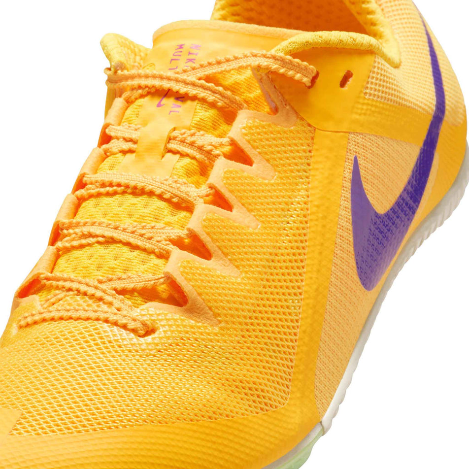 Close-up view of the upper of the left shoe from a pair of Nike Unisex Zoom Rival Track & Field Multi-Event Spikes in the Citron Pulse/Indigo Burst-Volt Glow colourway.