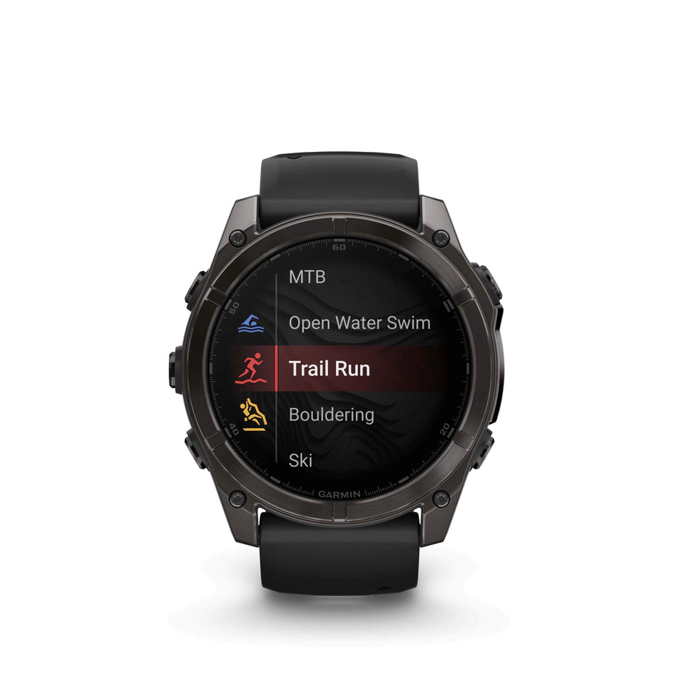 A Garmin fēnix 8 in the 51mm case size. Carbon grey DLC with Black/pebble grey silicone band. Trail run screen.