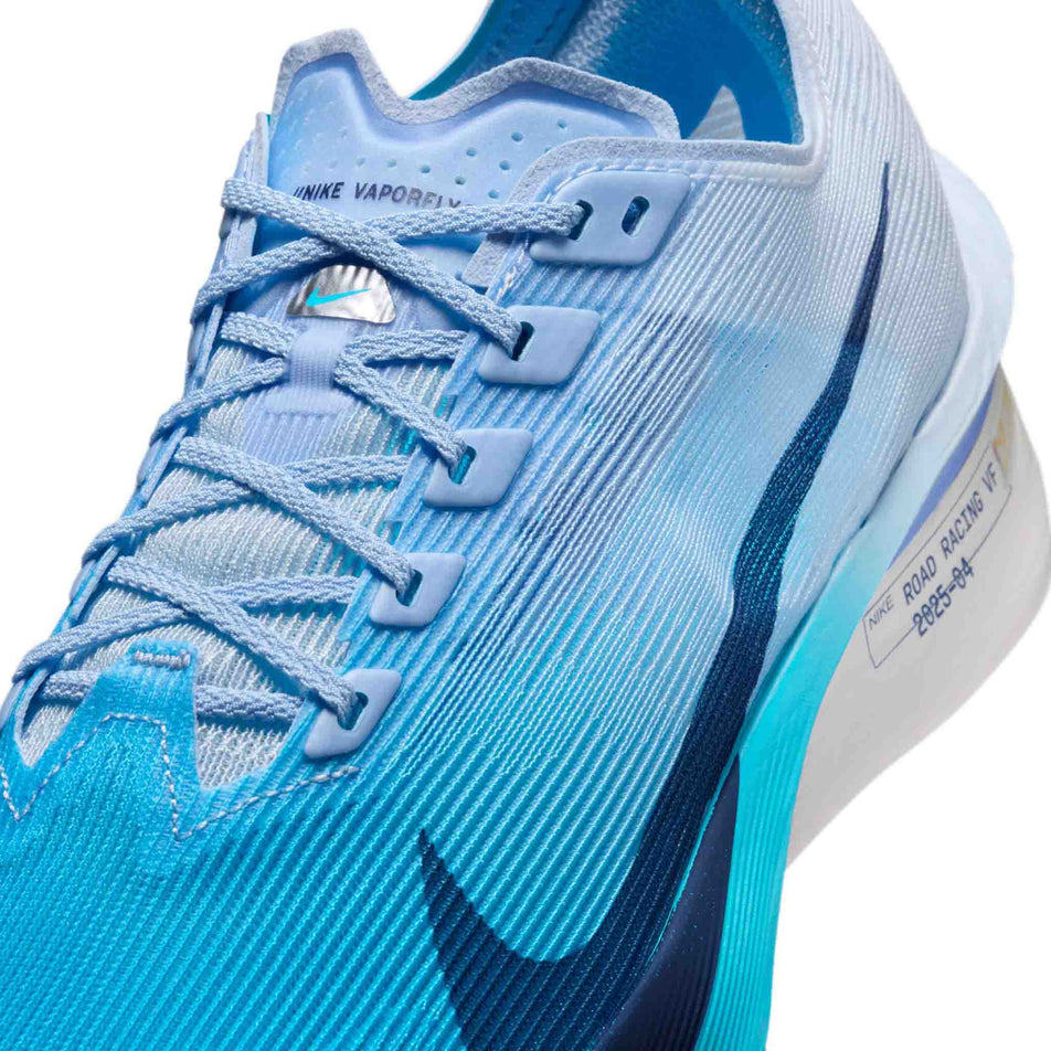 Close-up view of the upper of the left shoe from a pair of Nike Women's Vaporfly 4 Road Racing Shoes in the White/Midnight Navy-Hydrogen Blue colourway.