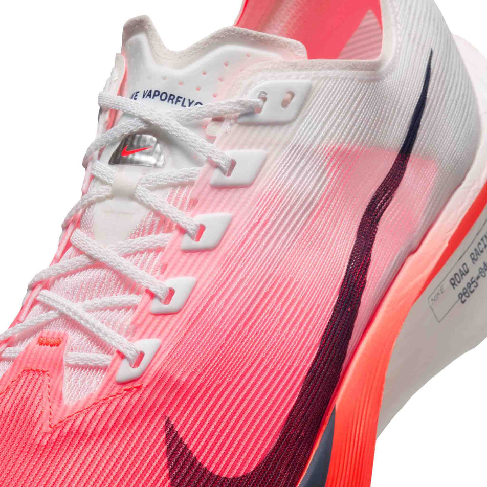 Close-up view of the upper of the left shoe from a pair of Nike Men's Vaporfly 4 Road Racing Shoes in the White/Midnight Navy-Bright Crimson colourway.