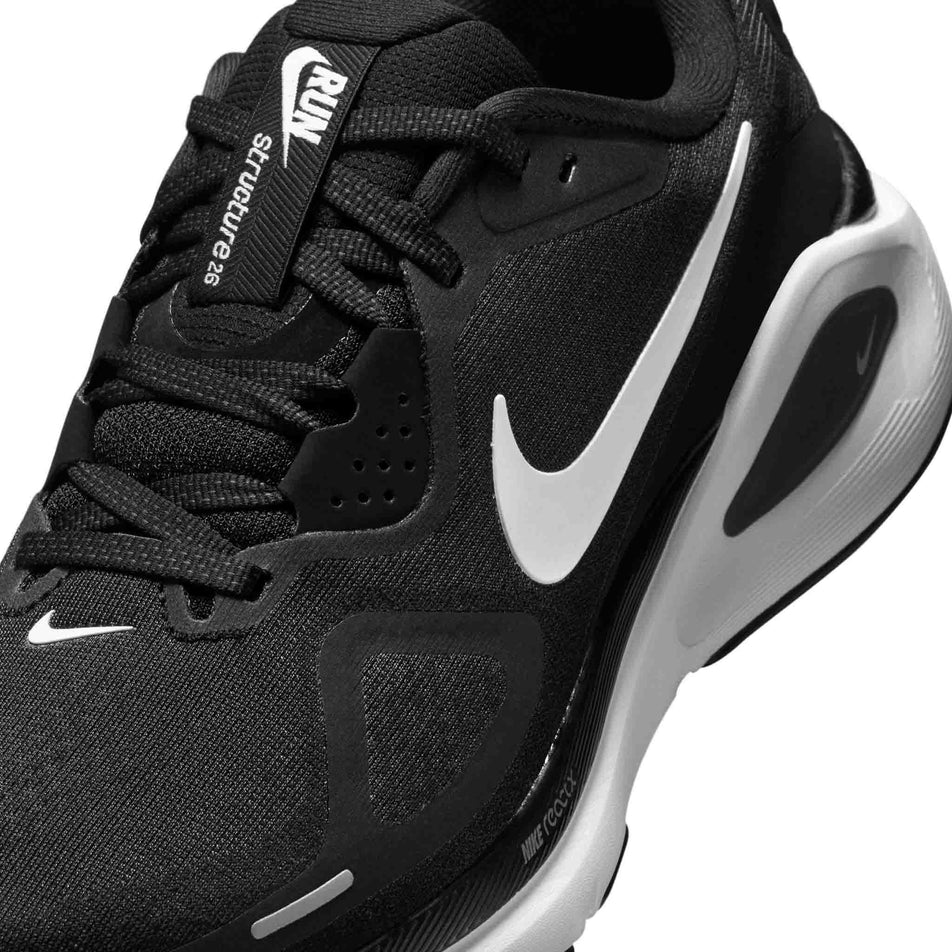 Close up of the upper of the left shoe from a pair of Nike Women's Structure 26 Road Running Shoes in the Black/White-Cool Grey-Metallic Silver colourway. (8686793982114)