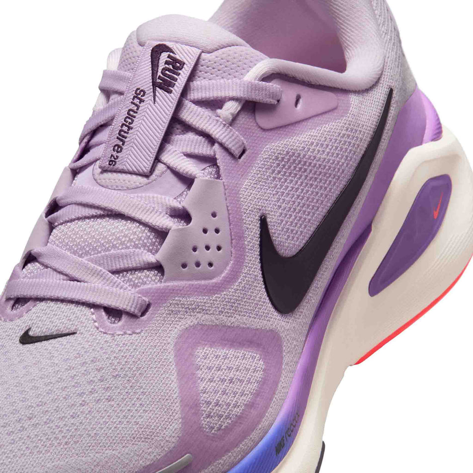Close-up view of the upper of the left shoe from a pair of Nike Women's Structure 26 Road Running Shoes in the Violet Mist/Cave Purple-Bright Violet colourway.
