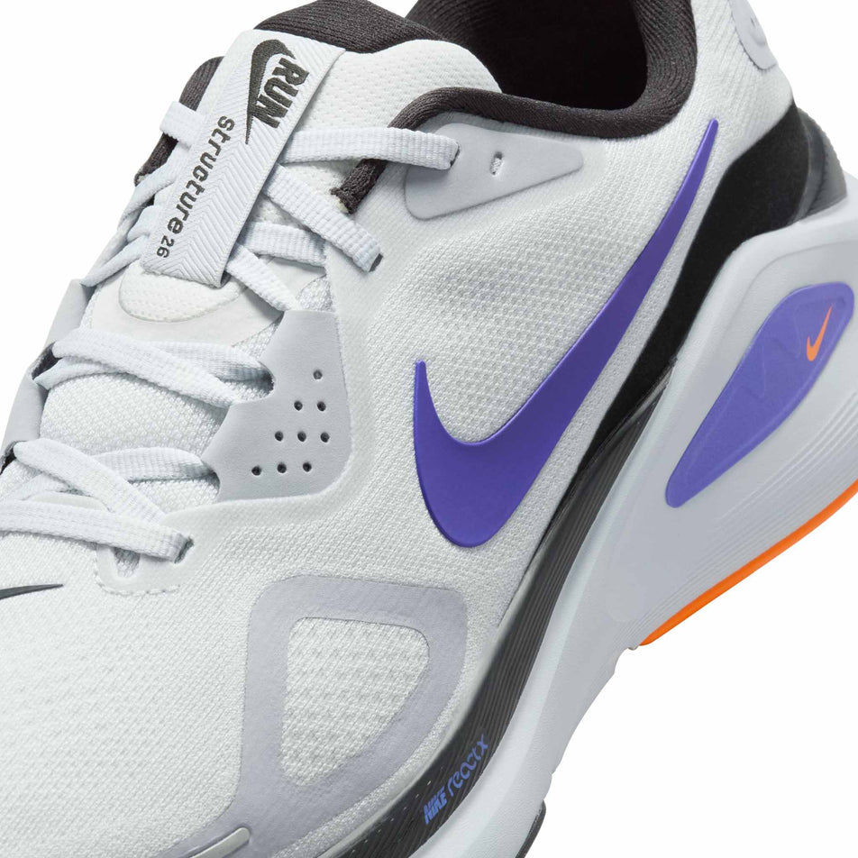 Close up of the upper of the left shoe from a pair of Nike Men's Structure 26 Road Running Shoes in the Pure Platinum/Persian Violet-Wolf Grey colourway. (8684597543074)
