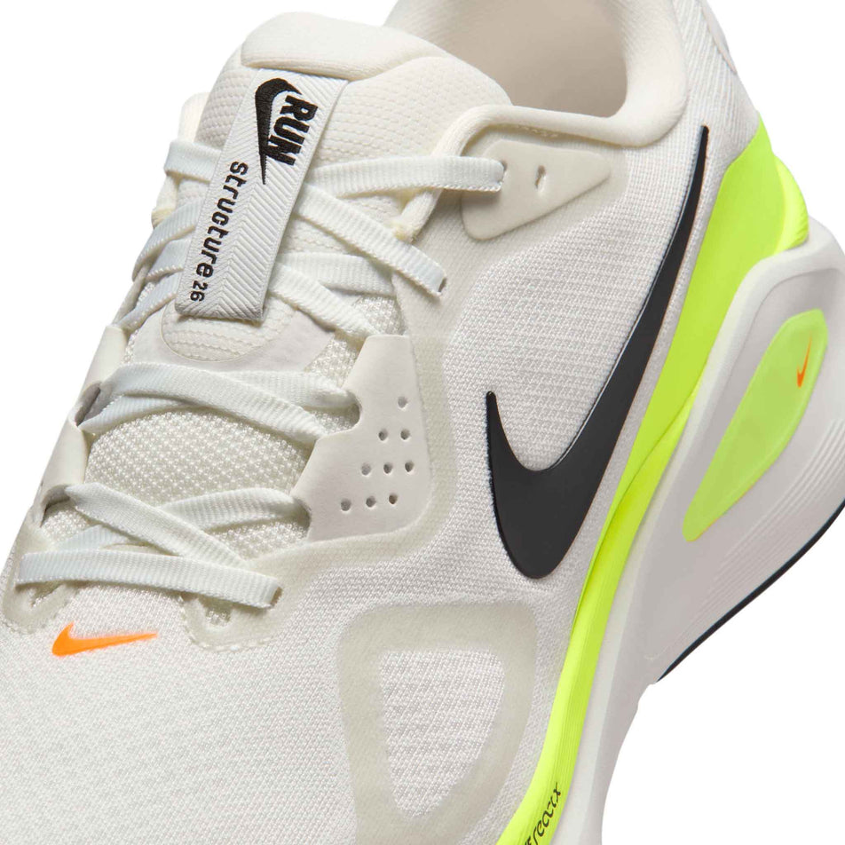 Close-up view of the upper of the left shoe from a pair of Nike Men's Structure 26 Road Running Shoes in the Summit White/Black-Volt-Total Orange colourway.