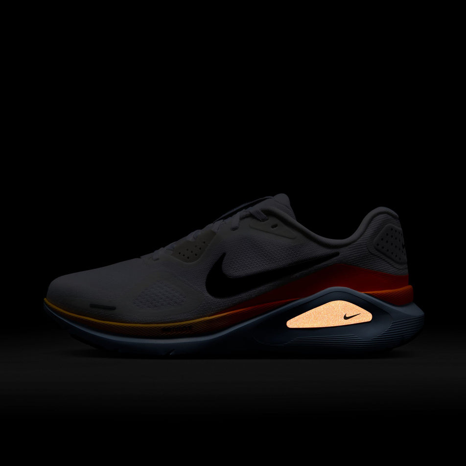 The reflective detail on the left shoe from a pair of Nike Men's Structure 26 Road Running Shoes in the White/Black-Hydrogen Blue-Total Orange colourway.