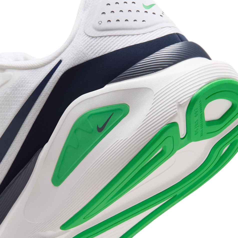 Close-up view of the rearfoot section of the left shoe from a pair of Nike Men's Structure 26 Road Running Shoes in the White/Midnight Navy-Green Spark colourway.