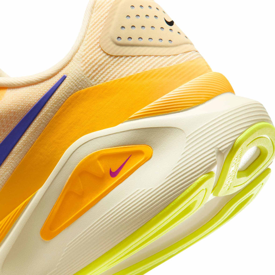 Close-up view of the rearfoot section of the left shoe from a pair of Nike Men's Structure 26 Road Running Shoes in the Alabaster/Indigo Burst-Hyper Violet colourway.