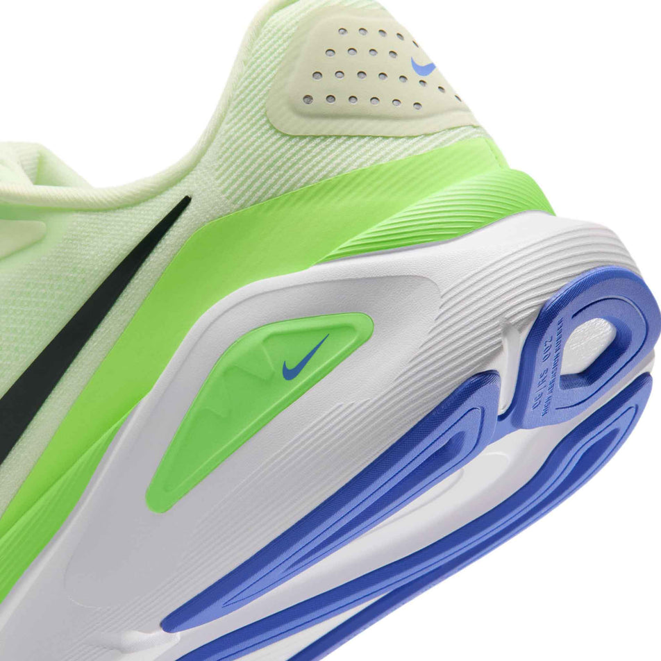 Close-up view of the rearfoot section of the left shoe from a pair of Nike Men's Structure 26 Road Running Shoes in the Volt Tint/Black Spruce-Lime Blast colourway.