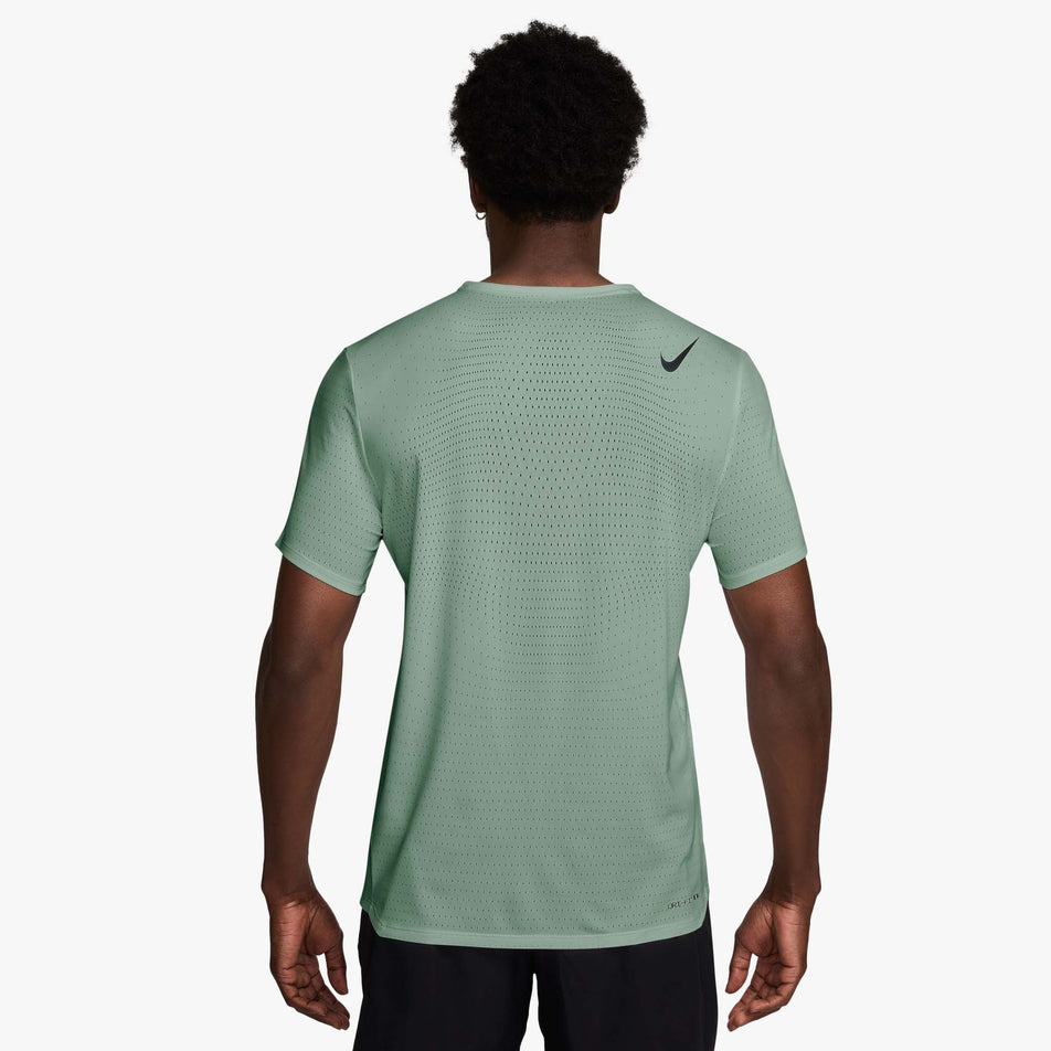 Back view of a model wearing the Nike Men's AeroSwift Dri-FIT ADV Short-Sleeve Running Top in the Steam/Black colourway.