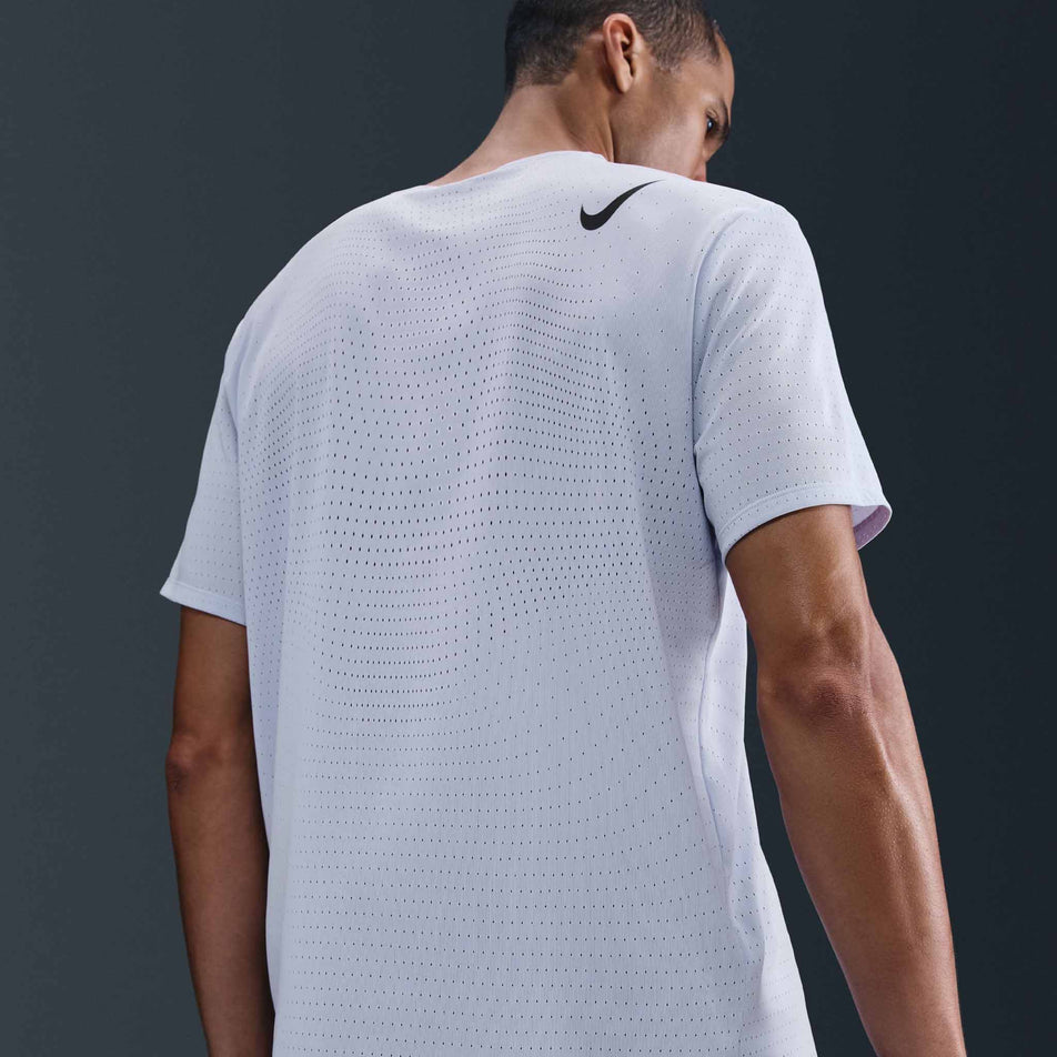 Back view of a model wearing the Nike Men's AeroSwift Dri-FIT ADV Short-Sleeve Running Top in the Ghost/Black colourway. (8710830620834)