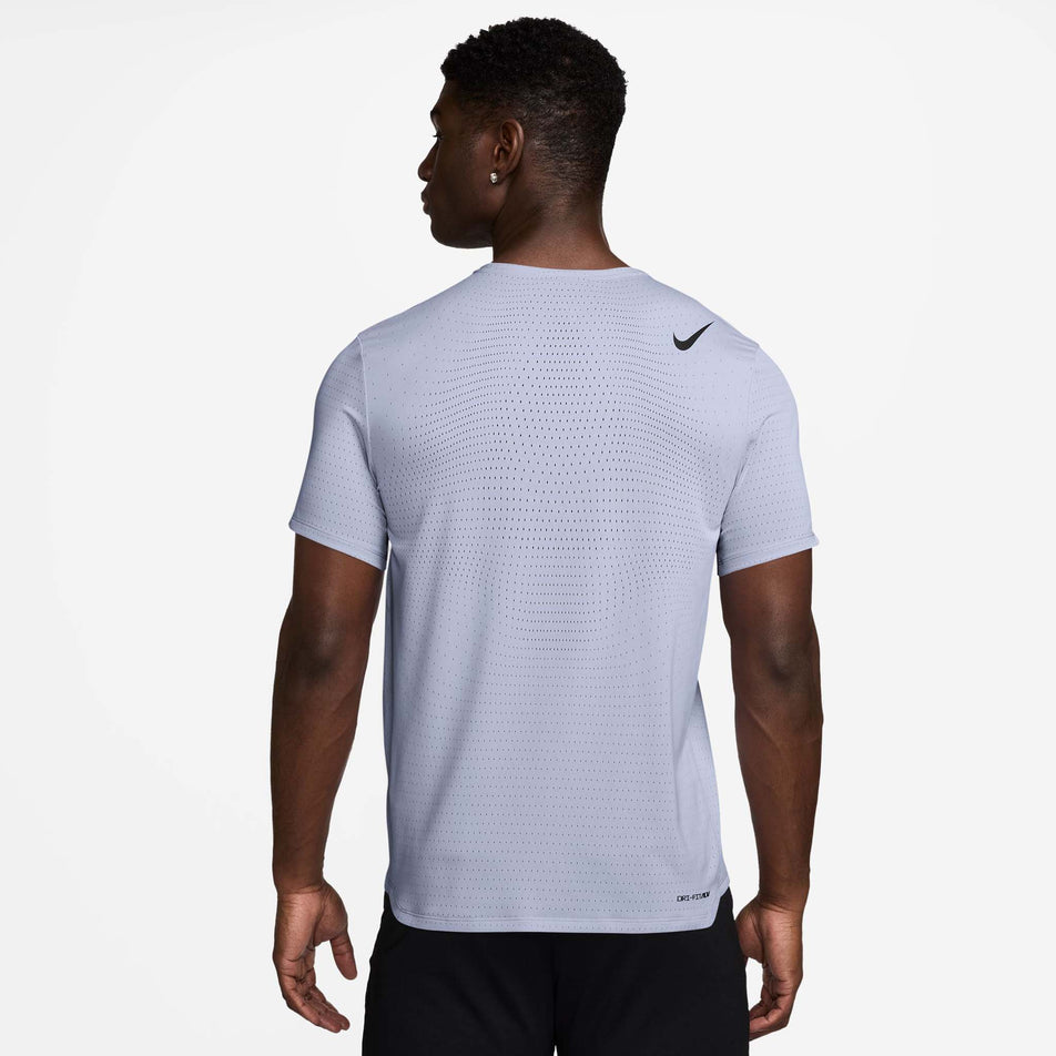 Back view of a model wearing the Nike Men's AeroSwift Dri-FIT ADV Short-Sleeve Running Top in the Ghost/Black colourway. (8710830620834)