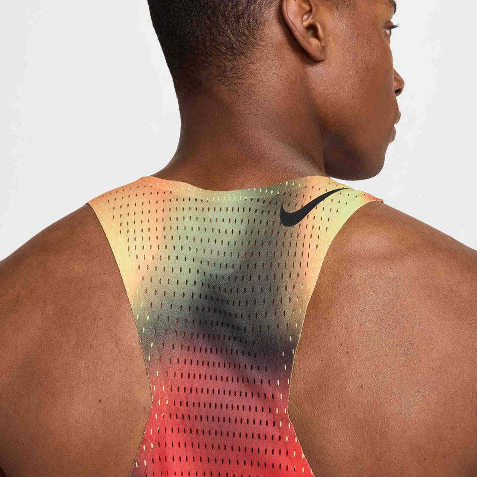Back view of a model wearing the Nike Men's Dri-FIT AeroSwift Elite Entry Singlet in the Light Lemon Twist/Light Crimson/Black/Black colourway. (8574167613602)