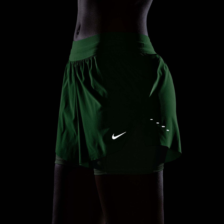 The reflective details on the Nike Women's Swift Dri-FIT Mid-Rise 2-in-1 Running Shorts in the Illusion Green colourway.
