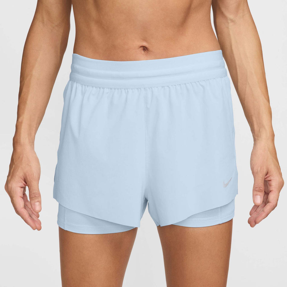 Front view of a model wearing a pair of Nike Women's Swift Dri-FIT Mid Rise 2-in-1 Running Shorts in the Blue Tint/Reflective Silv colourway (8620122800290)
