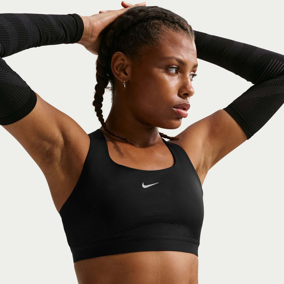 Front view of a model wearing the Nike Women's Swift High-Support Lightly Lined Sports Bra in the Black/Silver colourway.