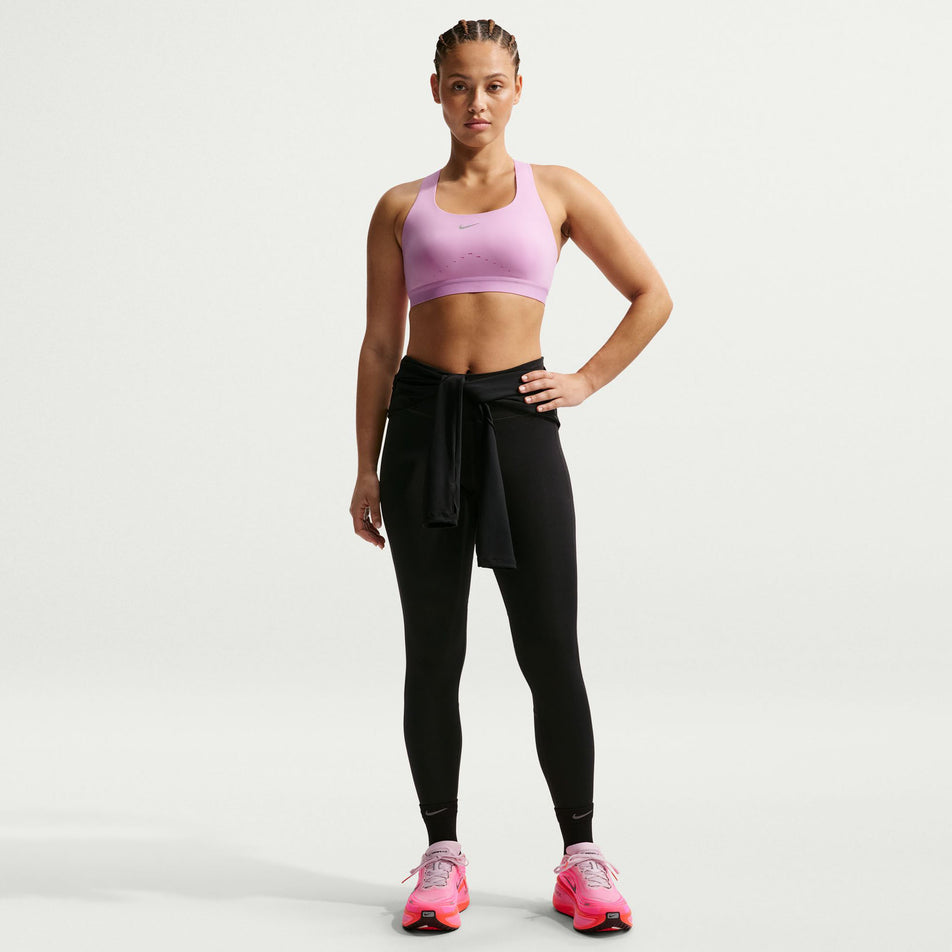 Front view of a model wearing the Nike Women's Swift High-Support Lightly Lined Sports Bra in the Light Magenta/Reflective Silver colourway.