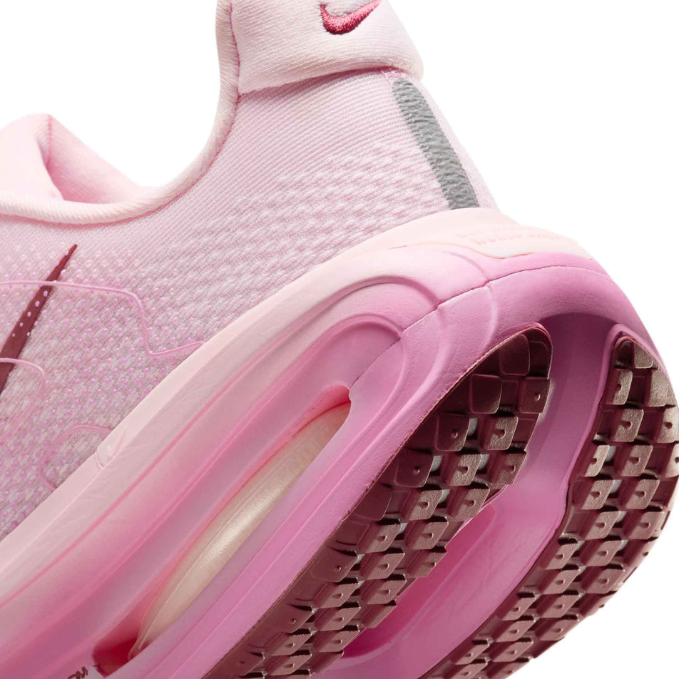 Close-up view of the rearfoot section of the left shoe from a pair of Nike Women's Vomero Premium Road Running Shoes in the Pink Foam/Pink Smoke-Pink Rise colourway.