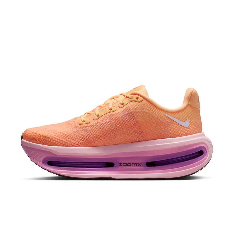 Medial view of the right shoe from a pair of Nike Women's Vomero Premium Road Running Shoes in the Tangerine Tint/Tattoo-Bright Crimson colourway.