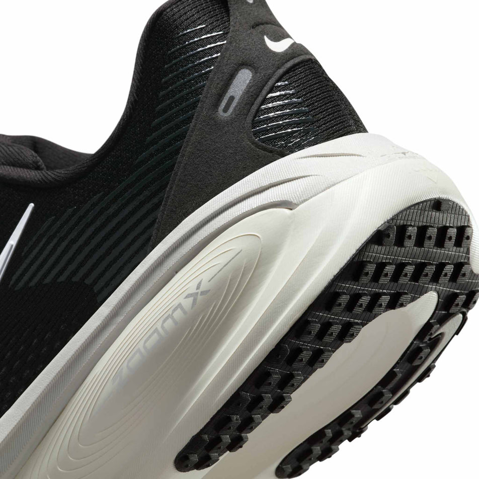 Close up of the midsole of the left shoe from a pair of Nike Men's Vomero 18 Road Running Shoes in the Black/Summit White-Coconut Milk colourway. (8684566708386)