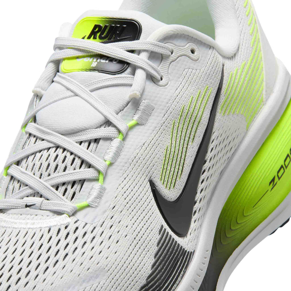 Close-up view of the upper of the left shoe from a pair of Nike Men's Vomero 18 Road Running Shoes in the Photon Dust/Black-Volt colourway.