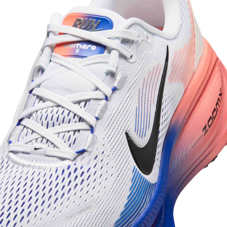 Close-up view of the upper of the left shoe from a pair of Nike Men's Vomero 18 Road Running Shoes in the White/Black-Racer Blue-Atomic Pink colourway.