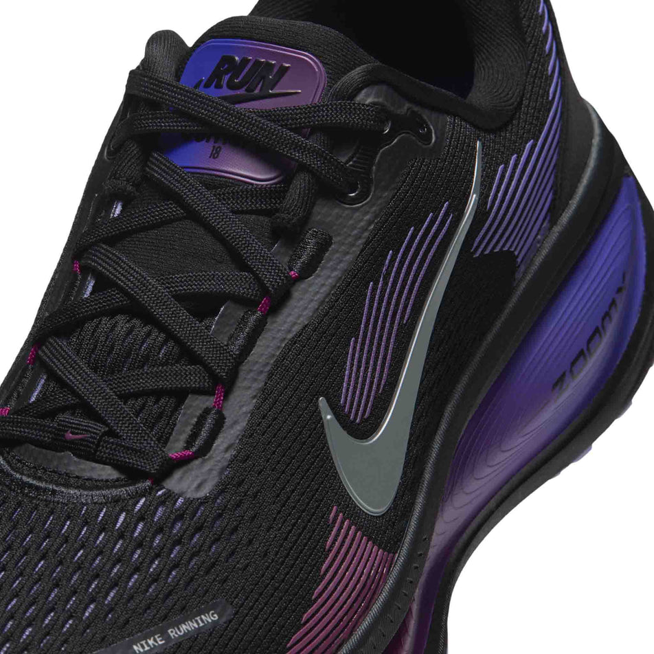 Close-up view of the upper of the left shoe from a pair of Nike Women's Vomero 18 Road Running Shoes in the Black/Metallic Silver-Persian Violet colourway.
