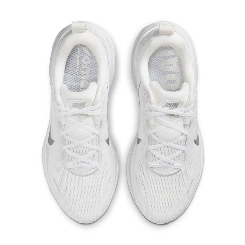 The uppers of a pair of Nike Women's Vomero 18 Road Running Shoes in the White/Metallic Silver-Photon Dust colourway. (8686789361826)