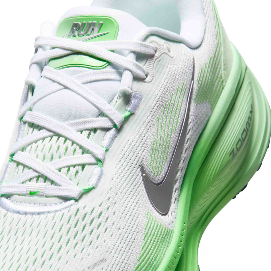 Close-up view of the upper of the left shoe from a pair of Nike Women's Vomero 18 Road Running Shoes in the White/Metallic Silver-Illusion Green colourway.