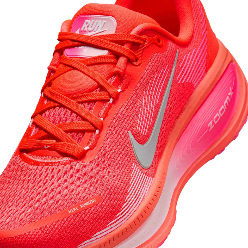 Close up of the upper of the left shoe from a pair of Nike Women's Vomero 18 Road Running Shoes in the Bright Crimson/White-Hyper Pink colourway. (8686791786658)
