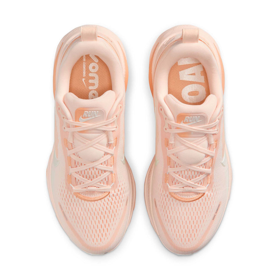 The uppers of a pair of Nike Women's Vomero 18 Road Running Shoes in the Guava Ice/Sail-Orange Chalk colourway.