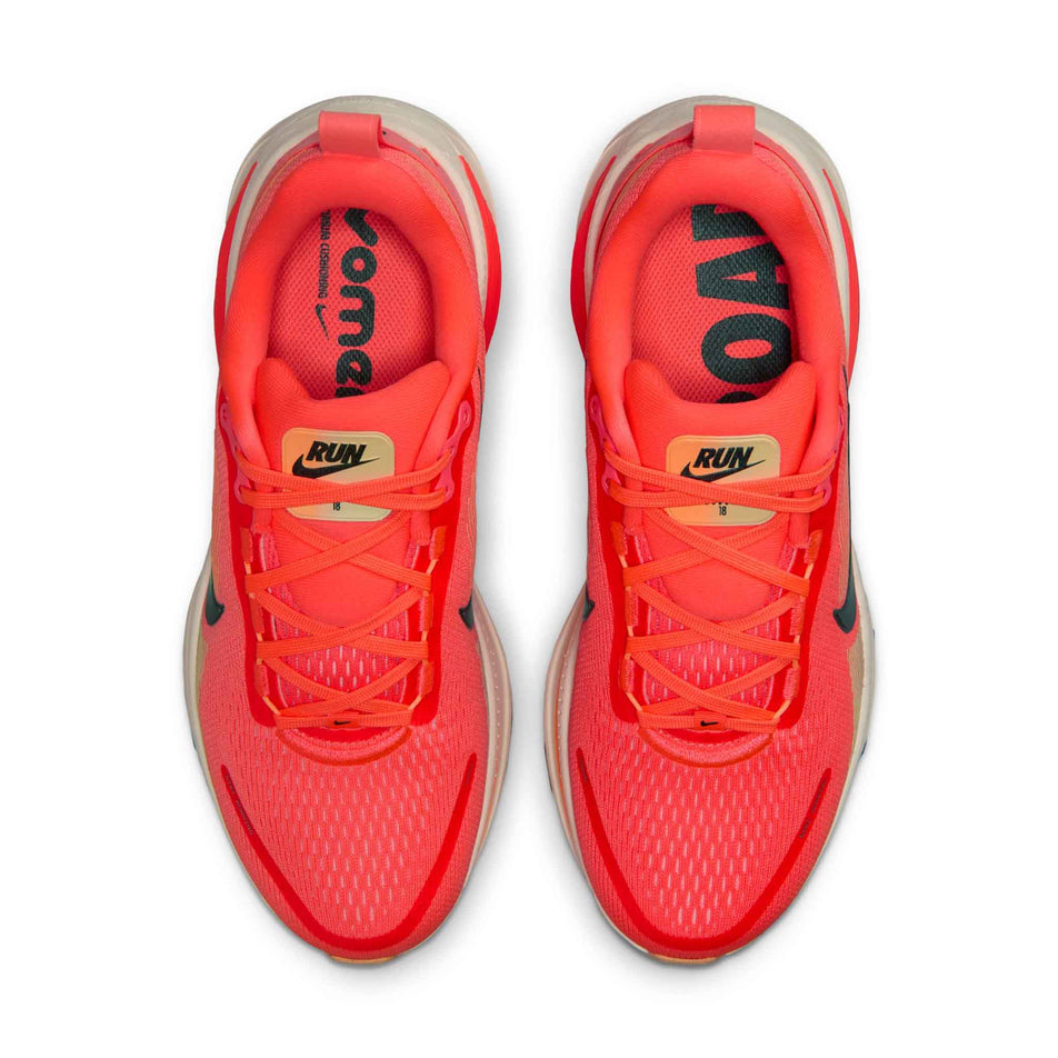 The uppers of a pair of Nike Women's Vomero 18 Road Running Shoes in the Hot Lava/Black-Chalk-Orange Pulse colourway.