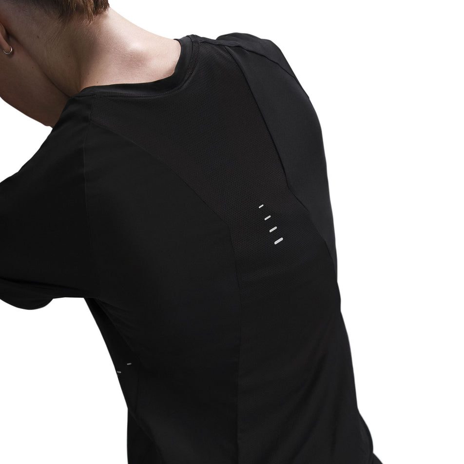 Back view of a model wearing a Nike Women's Swift Dri-FIT Short-Sleeve Running Top in the Black/Reflective Silver colourway. (8560479404194)