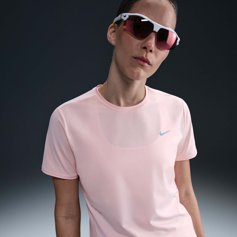 Front view of a model wearing the Nike Women's Swift Dri-FIT Short-Sleeve Running Top in the Atmosphere/Reflective Silver colourway. (8620130762914)