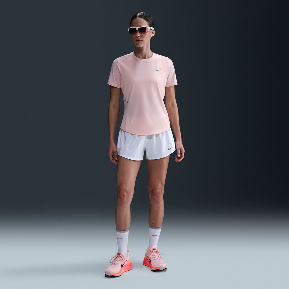 Front view of a model wearing the Nike Women's Swift Dri-FIT Short-Sleeve Running Top in the Atmosphere/Reflective Silver colourway. (8620130762914)