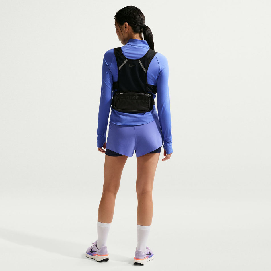 Back view of a model wearing the Nike Women's Swift Dri-FIT UV 1/4-Zip Running Top in the Sapphire/Reflective Silver colourway.