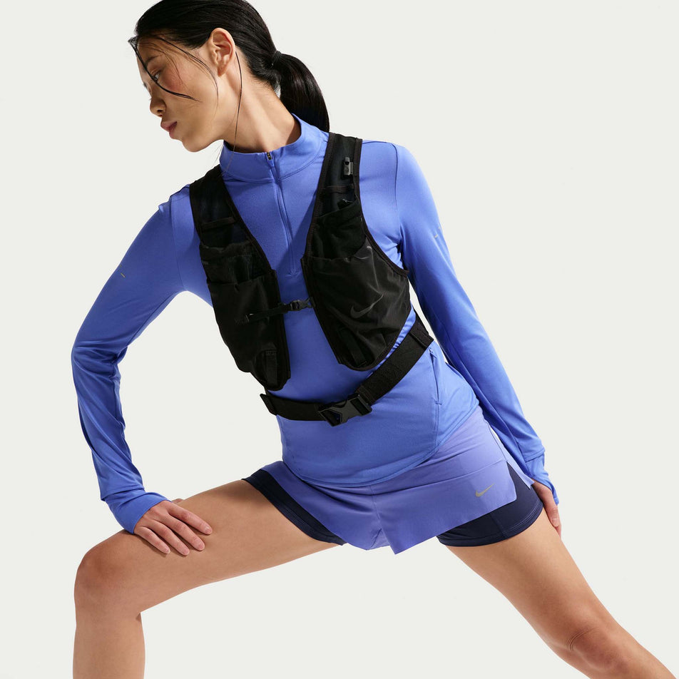 Front view of a model wearing the Nike Women's Swift Dri-FIT UV 1/4-Zip Running Top in the Sapphire/Reflective Silver colourway.