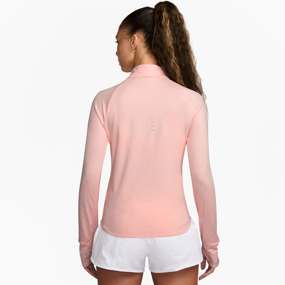 Back view of a model wearing the Nike Women's Swift Dri-FIT UV 1/4-Zip Long Sleeve Running Top in the Atmosphere/Heather/Reflective Silver colourway. (8621654081698)