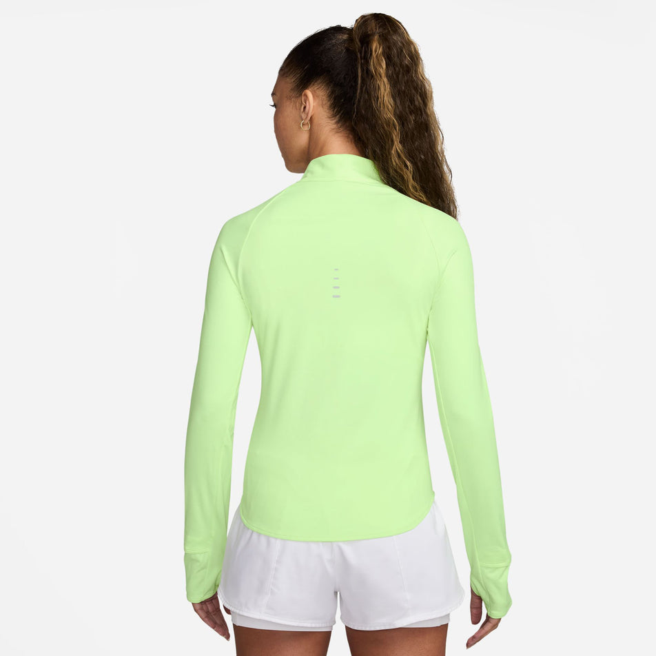 Back view of a model wearing the Nike Women's Swift Dri-FIT UV 1/4-Zip Long Sleeve Running Top in the Barely Volt/Heather/Reflective Silver colourway. (8621858193570)