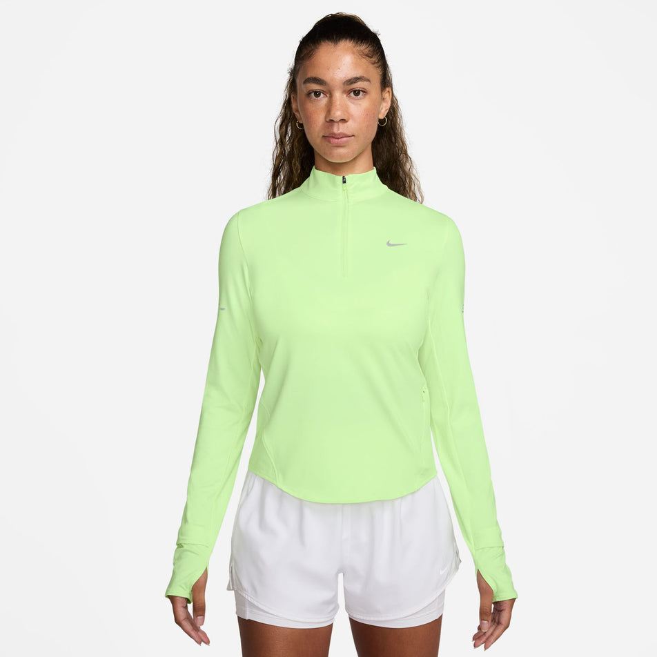 Front view of a model wearing the Nike Women's Swift Dri-FIT UV 1/4-Zip Long Sleeve Running Top in the Barely Volt/Heather/Reflective Silver colourway. (8621858193570)