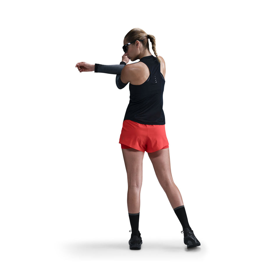 Back view of a model wearing a Nike Women's Swift Dri-FIT Running Tank Top in the Black/Reflective Silver colourway. (8560470524066)