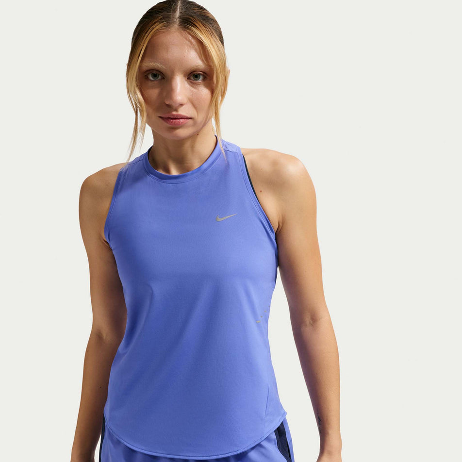 Front view of a model wearing the Nike Women's Swift Dri-FIT Running Tank Top in the Sapphire/Reflective Silver colourway.