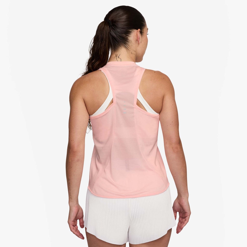 Back view of a model wearing the Nike Women's Swift Dri-FIT Running Tank Top in the Atmosphere/Reflective Silver colourway. (8620139970722)