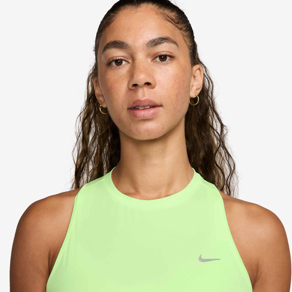 Front view of a model wearing the Nike Women's Swift Dri-FIT Running Tank Top in the Barely Volt/Reflective Silver colourway. (8620142952610)